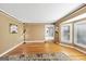 Classic living room showcasing hardwood floors, large windows, and a clean, open space at 5045 Rock Springs Rd, Lithonia, GA 30038