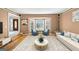 Bright living room featuring large windows, hardwood floors, and a comfortable seating arrangement at 5045 Rock Springs Rd, Lithonia, GA 30038
