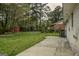 View of a spacious backyard with a concrete patio and a storage shed near the treeline at 7017 Sun Valley Way, Riverdale, GA 30274