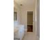 White bathroom with single vanity, and tile floor at 7017 Sun Valley Way, Riverdale, GA 30274