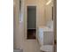 White bathroom with white vanity and commode and tile floor at 7017 Sun Valley Way, Riverdale, GA 30274