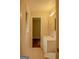 Bathroom with neutral tile flooring, window, and white vanity with plenty of storage at 7017 Sun Valley Way, Riverdale, GA 30274