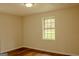 Bright bedroom featuring wood-look floors and a window view at 7017 Sun Valley Way, Riverdale, GA 30274