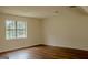 Bright bedroom with a large window, dark laminate floors and fresh paint at 7017 Sun Valley Way, Riverdale, GA 30274