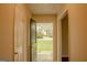 Sunlit entryway showcasing a vibrant green front door and outdoor view at 7017 Sun Valley Way, Riverdale, GA 30274