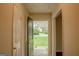 Inviting entryway with a view of the front yard through a stylish glass-paneled front door at 7017 Sun Valley Way, Riverdale, GA 30274