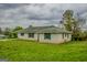 Ranch-style home with a white brick exterior, green shutters, and a well-maintained lawn at 7017 Sun Valley Way, Riverdale, GA 30274