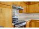 Traditional kitchen featuring wooden cabinets and black appliances at 7017 Sun Valley Way, Riverdale, GA 30274