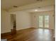 Open-concept living space featuring French doors and neutral decor, perfect for modern living at 7017 Sun Valley Way, Riverdale, GA 30274