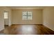 Empty living room with natural light, laminate floors and fresh paint at 7017 Sun Valley Way, Riverdale, GA 30274