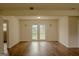 Bright, spacious living room with wood floors and a patio door leading to the outside at 7017 Sun Valley Way, Riverdale, GA 30274