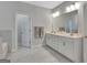 Bathroom featuring a double sink vanity with cabinets and a large mirror at 221 Caledonia Ct, Peachtree City, GA 30269