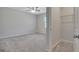 Empty bedroom featuring neutral walls, carpeted floor, window, and a door to the closet at 221 Caledonia Ct, Peachtree City, GA 30269