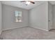 Empty bedroom featuring neutral walls, carpeted floor, window, and a door to the closet at 221 Caledonia Ct, Peachtree City, GA 30269