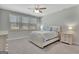 Comfortable bedroom features plush carpet, a ceiling fan, and natural light at 221 Caledonia Ct, Peachtree City, GA 30269