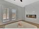 Bright bedroom with wood floors, french doors, and a modern fireplace at 221 Caledonia Ct, Peachtree City, GA 30269