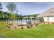 Beautifully landscaped community pool with a wrought-iron fence and a grassy area at 221 Caledonia Ct, Peachtree City, GA 30269