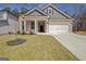 Inviting home with a well-kept lawn, complemented by a two-car garage and a quaint front porch at 221 Caledonia Ct, Peachtree City, GA 30269