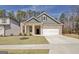 Charming single-Gathering home featuring a well-manicured lawn, a two-car garage, and a welcoming front porch at 221 Caledonia Ct, Peachtree City, GA 30269