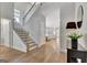 Spacious foyer featuring a staircase, stylish decor, and an inviting view into the home's interior at 221 Caledonia Ct, Peachtree City, GA 30269