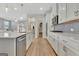 Bright kitchen with gray backsplash, stainless appliances, large island and access to walk-in pantry at 221 Caledonia Ct, Peachtree City, GA 30269