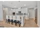 Beautiful kitchen featuring an island with barstool seating, modern appliances, and light-toned wood flooring at 221 Caledonia Ct, Peachtree City, GA 30269