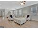 Spacious living room with large, comfortable sectional, plush ottoman, and ample natural light at 221 Caledonia Ct, Peachtree City, GA 30269
