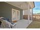 Covered patio with wicker chairs, ceiling fan, and double doors leading indoors at 221 Caledonia Ct, Peachtree City, GA 30269