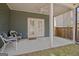 Covered patio with wicker chairs, ceiling fan, and double doors leading indoors at 221 Caledonia Ct, Peachtree City, GA 30269