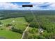 Aerial view showcasing a home nestled within a vast landscape, bordered by lush greenery and open fields, 333 Old Carrollton Road at 333 Old Carrollton Rd, Roopville, GA 30170