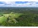 Expansive aerial view of land and wooded property with a private residence at 333 Old Carrollton Rd, Roopville, GA 30170
