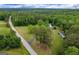 A beautiful aerial view showcases a property with mature trees and a long driveway off of a quite road at 333 Old Carrollton Rd, Roopville, GA 30170