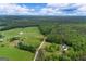 Aerial view of land showcasing a beautiful home surrounded by fields and wooded areas at 333 Old Carrollton Rd, Roopville, GA 30170