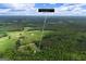 Aerial view of a home with a mix of dense woods and open fields, offering a blend of privacy and expansive views, 333 Old Carrollton Road at 333 Old Carrollton Rd, Roopville, GA 30170