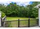 Private deck offering a serene view of the lush green yard, perfect for relaxing and enjoying the peaceful surroundings at 333 Old Carrollton Rd, Roopville, GA 30170