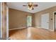 Empty bedroom featuring hardwood floors, natural light, ceiling fan, and neutral paint at 333 Old Carrollton Rd, Roopville, GA 30170