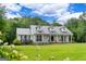 Charming white farmhouse with a metal roof, dormers, and expansive green lawn at 333 Old Carrollton Rd, Roopville, GA 30170