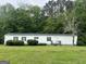 Mobile home with black shutters and a metal roof at 333 Old Carrollton Rd, Roopville, GA 30170
