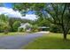 Beautiful home with a long driveway and scenic views of the surrounding lush, green landscaping at 333 Old Carrollton Rd, Roopville, GA 30170