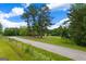 Long road leading to house with expansive green lawn and tall trees at 333 Old Carrollton Rd, Roopville, GA 30170