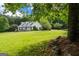 Picturesque front yard of a home with a sprawling green lawn, mature trees, and well-maintained landscaping at 333 Old Carrollton Rd, Roopville, GA 30170