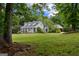 Charming home with a well-maintained front lawn and mature trees offering a picturesque and serene environment at 333 Old Carrollton Rd, Roopville, GA 30170