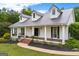 Charming home featuring a metal roof, inviting porch, and beautifully landscaped front yard at 333 Old Carrollton Rd, Roopville, GA 30170