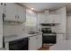 Updated kitchen with modern appliances and sink, featuring natural light from the window at 333 Old Carrollton Rd, Roopville, GA 30170
