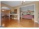 The open concept living room features hardwood floors, detailed archways, and a dining space with fine furnishings at 333 Old Carrollton Rd, Roopville, GA 30170