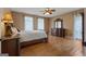 Spacious main bedroom featuring hardwood floors, ceiling fan and ample natural light from the windows at 333 Old Carrollton Rd, Roopville, GA 30170