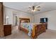 Spacious main bedroom with ceiling fan, en-suite bathroom, and a comfortable wooden bed frame at 333 Old Carrollton Rd, Roopville, GA 30170
