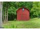 Red outbuilding on a well-maintained lawn with lush greenery at 333 Old Carrollton Rd, Roopville, GA 30170