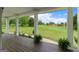 Covered porch with wooden floors and serene views of the lush, green yard and open skies at 333 Old Carrollton Rd, Roopville, GA 30170