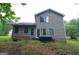 Backyard view with a patio and hot tub, framed by mature trees and lush greenery at 5851 Giles Rd, Lithonia, GA 30058